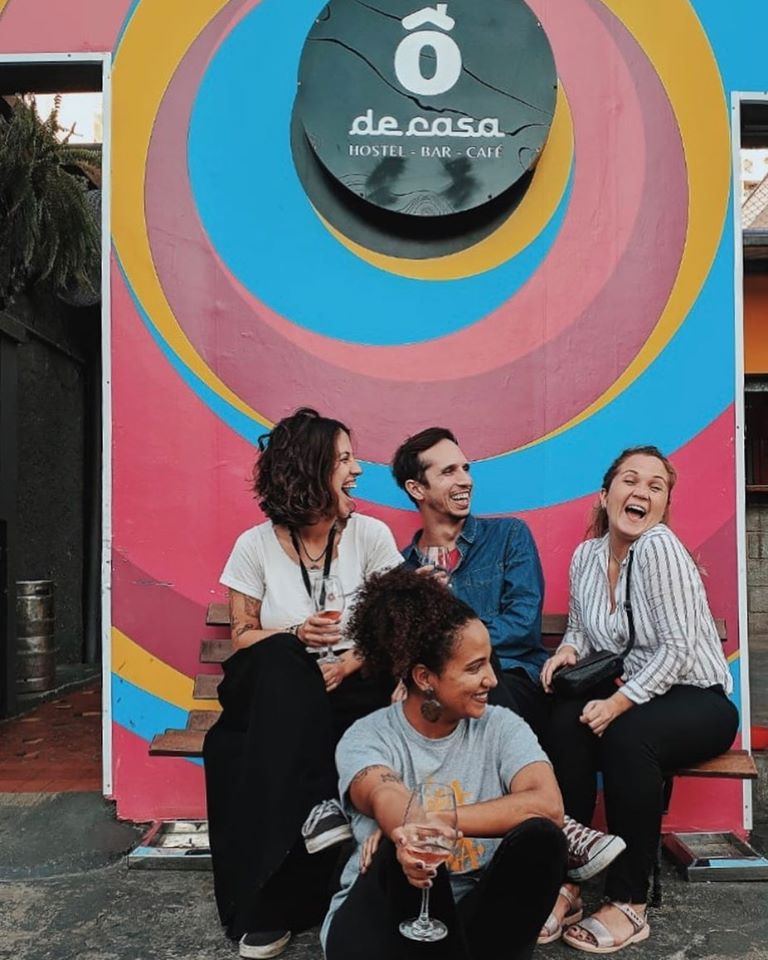 best independent hostels, people sitting with drinks outside Ô De Casa Hostel, São Paulo, Brazil