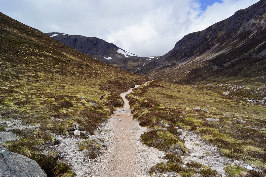 scotland road trip, path surrounded by mountains through cairngorms national park