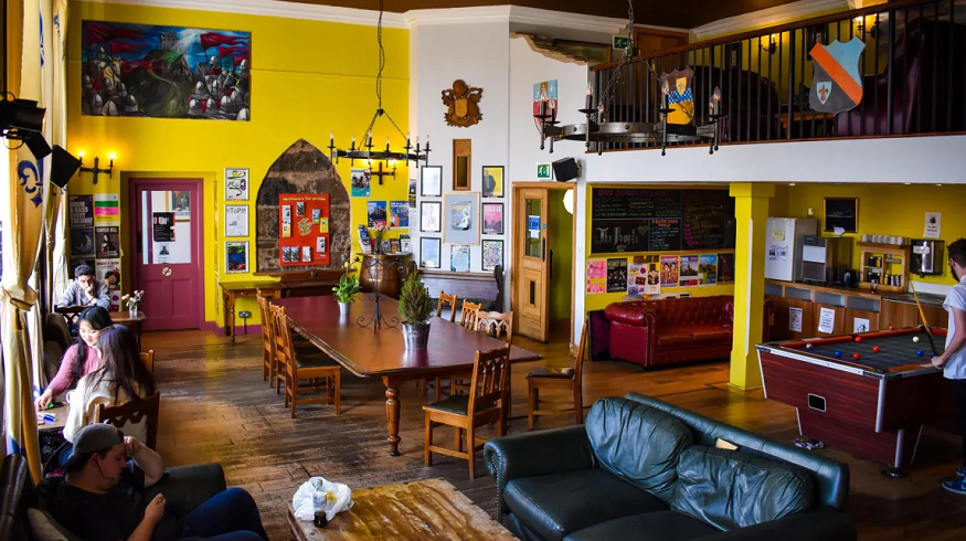 scotland road trip, social area with tables, sofas and pool tables at Castle Rock Hostel